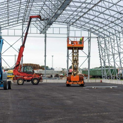 Lift with platform work in warehouse hangar construction field.